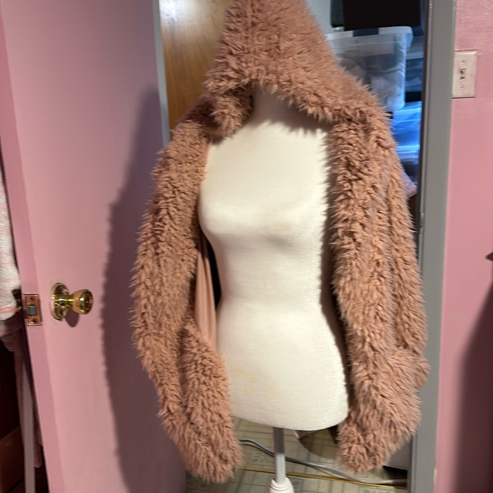 Fluffy jacket/hoodie. It isn’t beige. It is a coral with shimmery material.